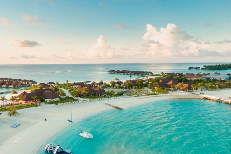 Overwater villas and turquoise lagoon at a tropical island resort — destinations available on request